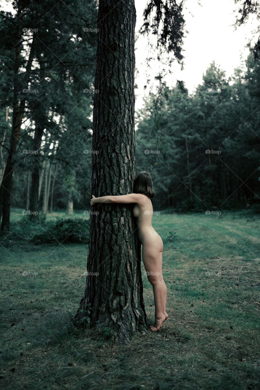 a naked woman in the forest