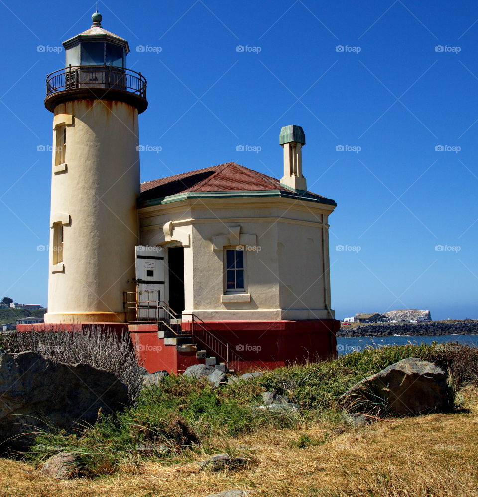 The old lighthouse stands guard where the Coquille River enters the Pacific Ocean at Bandon, Oregon. 