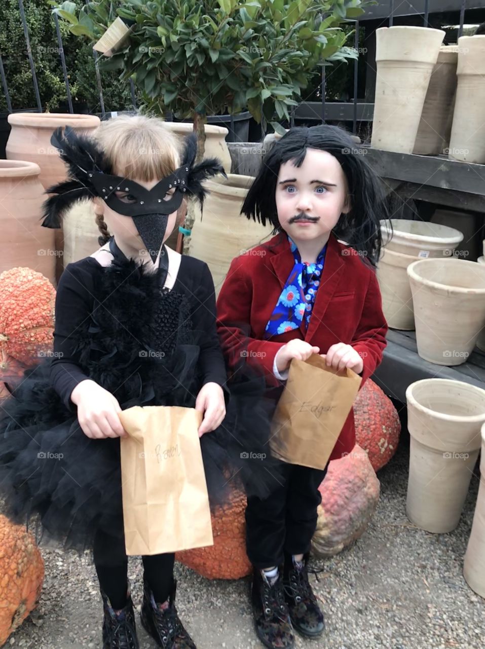 Children trick or treating as Edgar Allan Poe and Raven