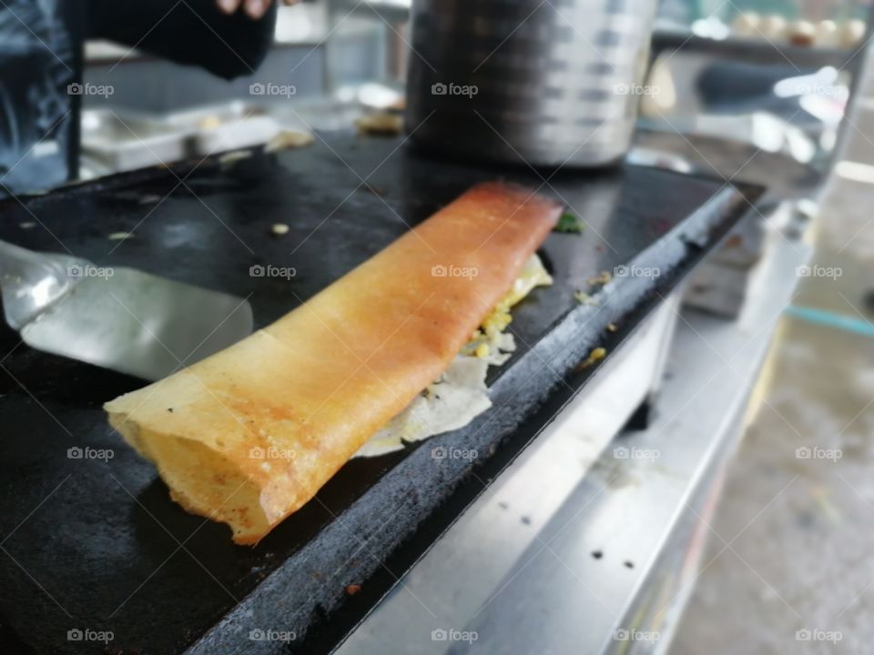 Dosa ready to serve. Its main ingredients are rice and black gram ground together in a fine, smooth batter with a dash of salt.Dosas are a typical part of the Southern Indian
but the dish is now popular all over the Indian subcontinent.