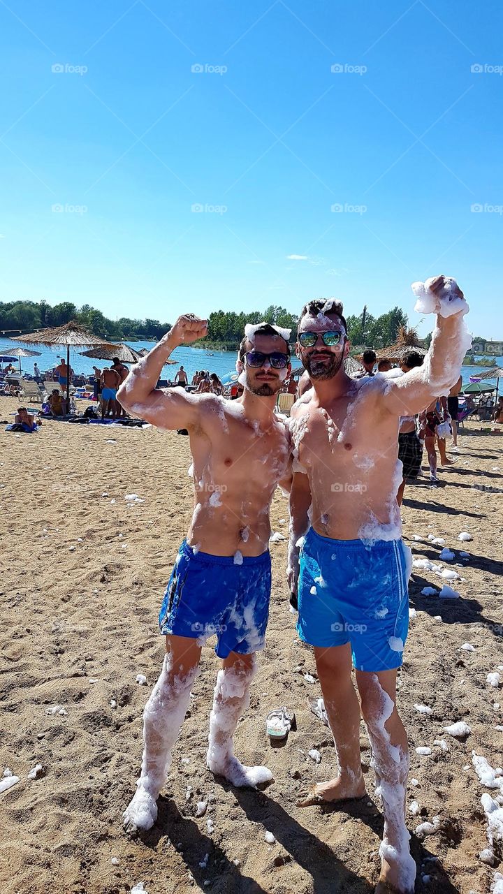 me and my brother at the foam party on the shore of Ghioroc Lake, Romania