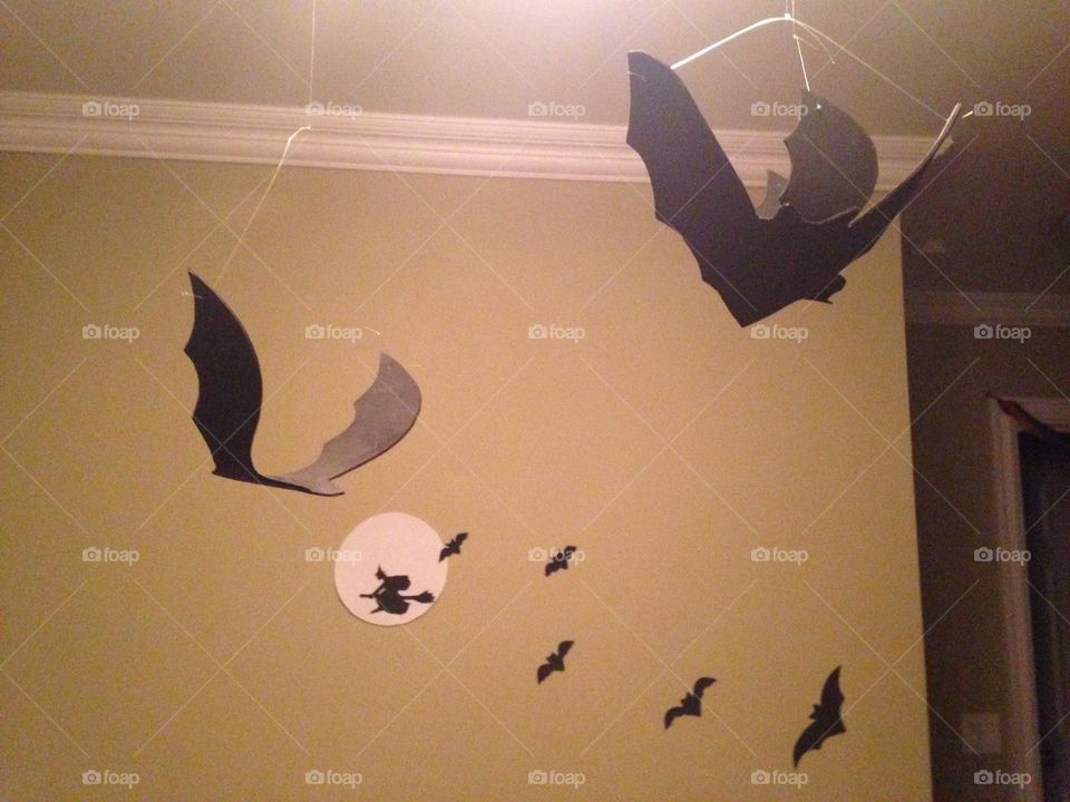 Hanging homemade bats and witch decorations