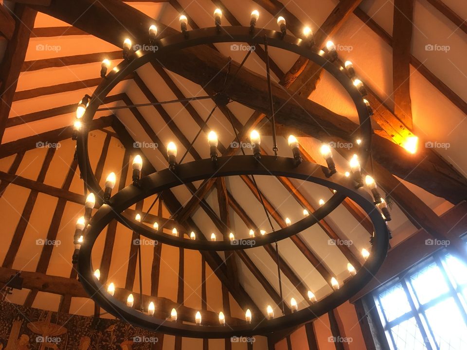 Set of two circular sets of lights suspended from the roof of the Waterend Barn pub in St Albans, Hertfordshire. Visited in Winter.