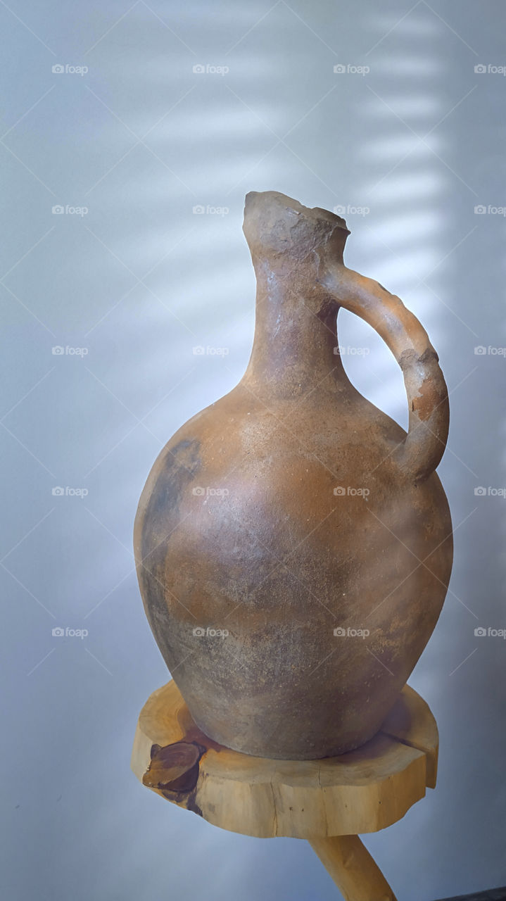 Clay pottery on a wooden shelf