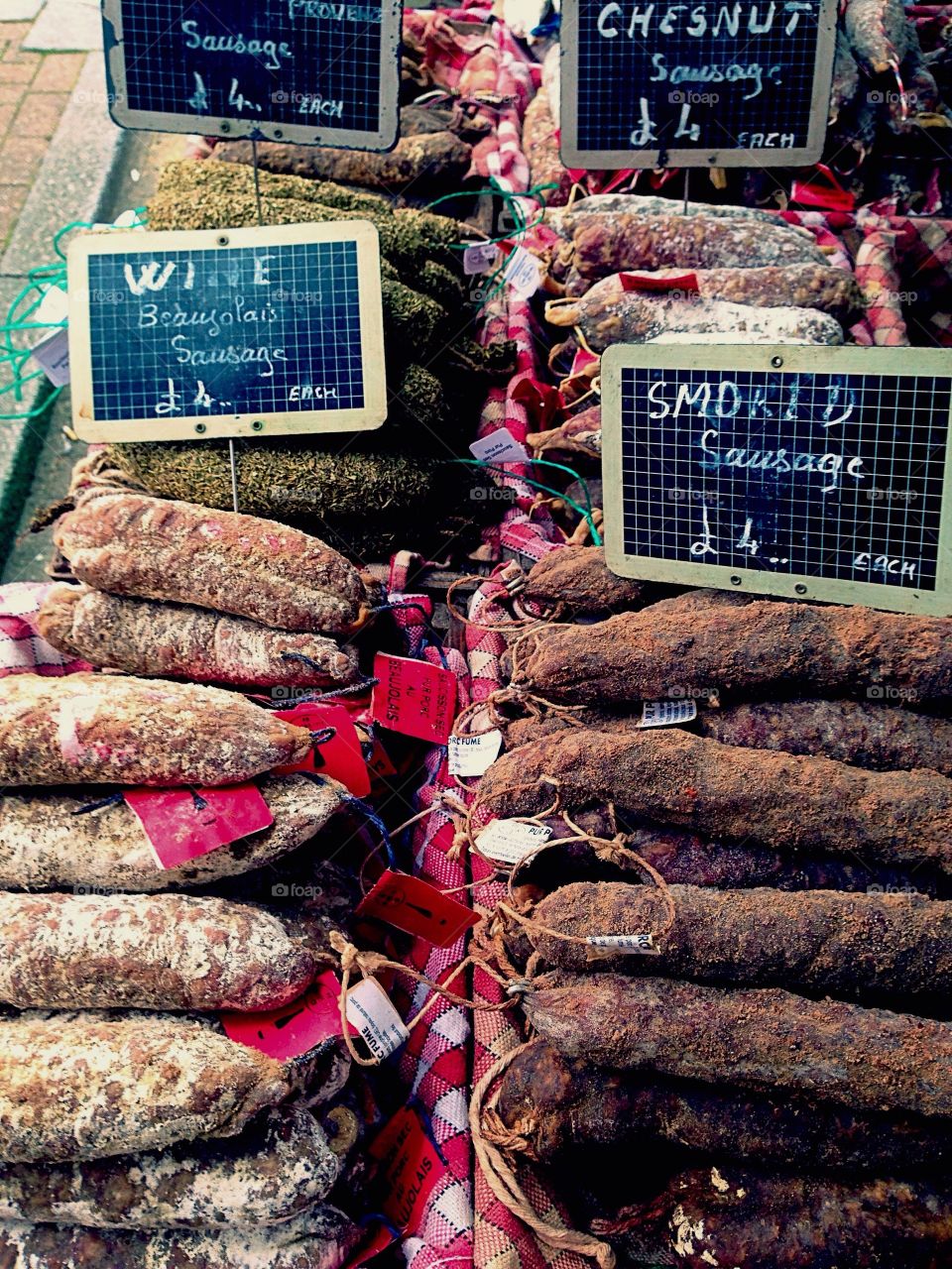 Selection of French dried sausages on a market stall 