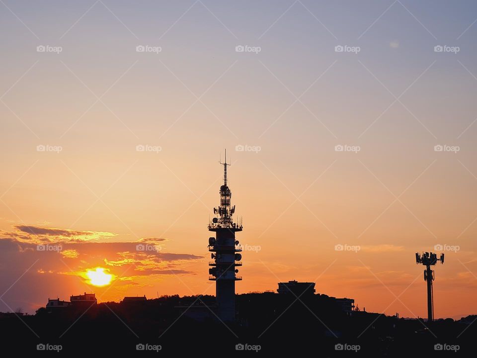 sunset silhouette of a telecommunications antenna