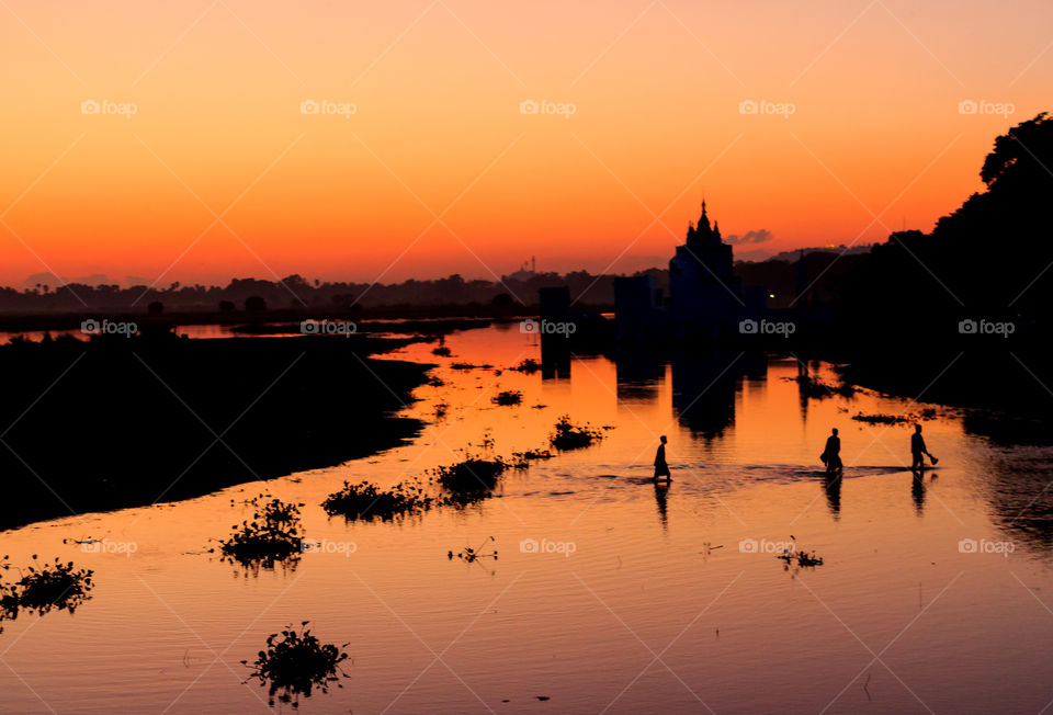 Coming home. Fishermen crossing lake to go home during sunset in Myanmar