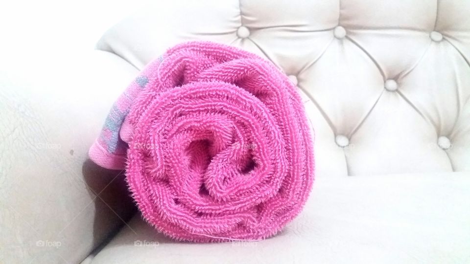 Close-up of pink rolled up towel