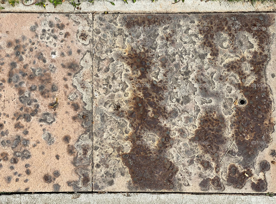 Corroded and rusted metal sidewalk plates