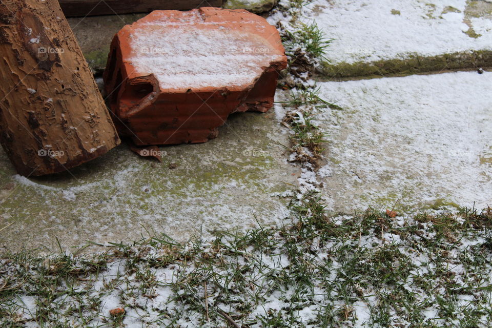 concrete with snow with red brick and wooden log