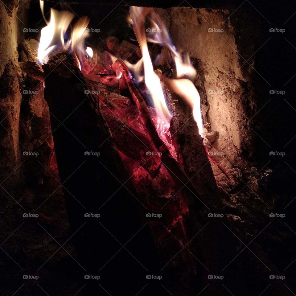 A close-up photo of the fire smoldering and blazing.
