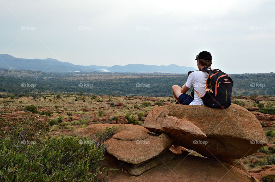 Missing hiking in a dry vast landscape dotted with green bushes