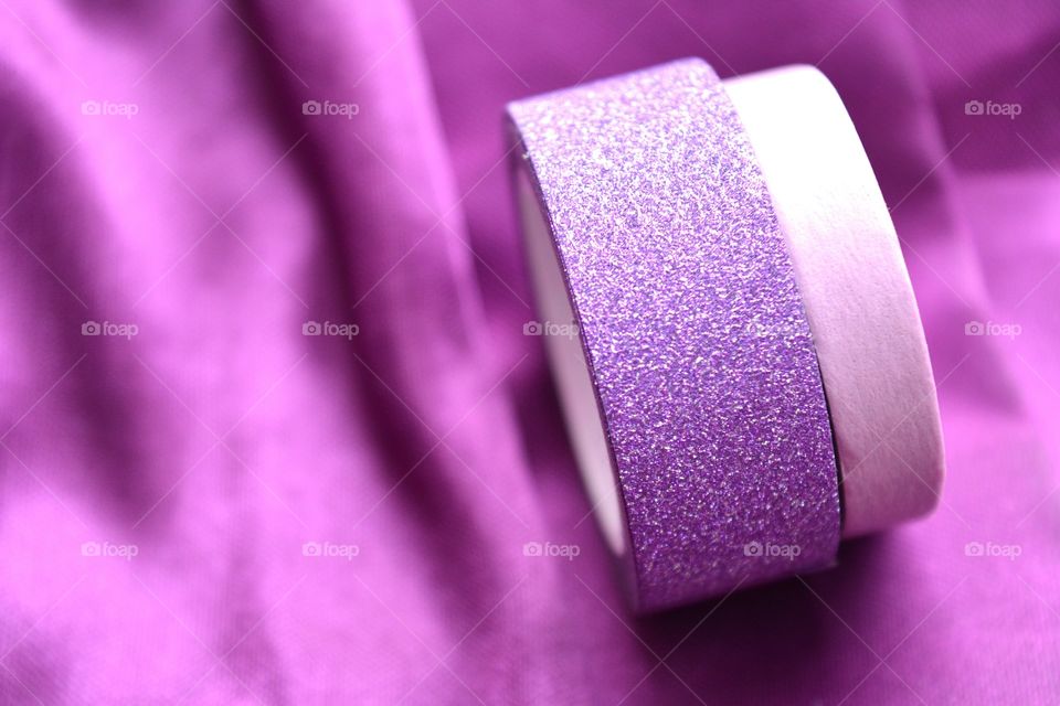 Two ribbons againts purple background
