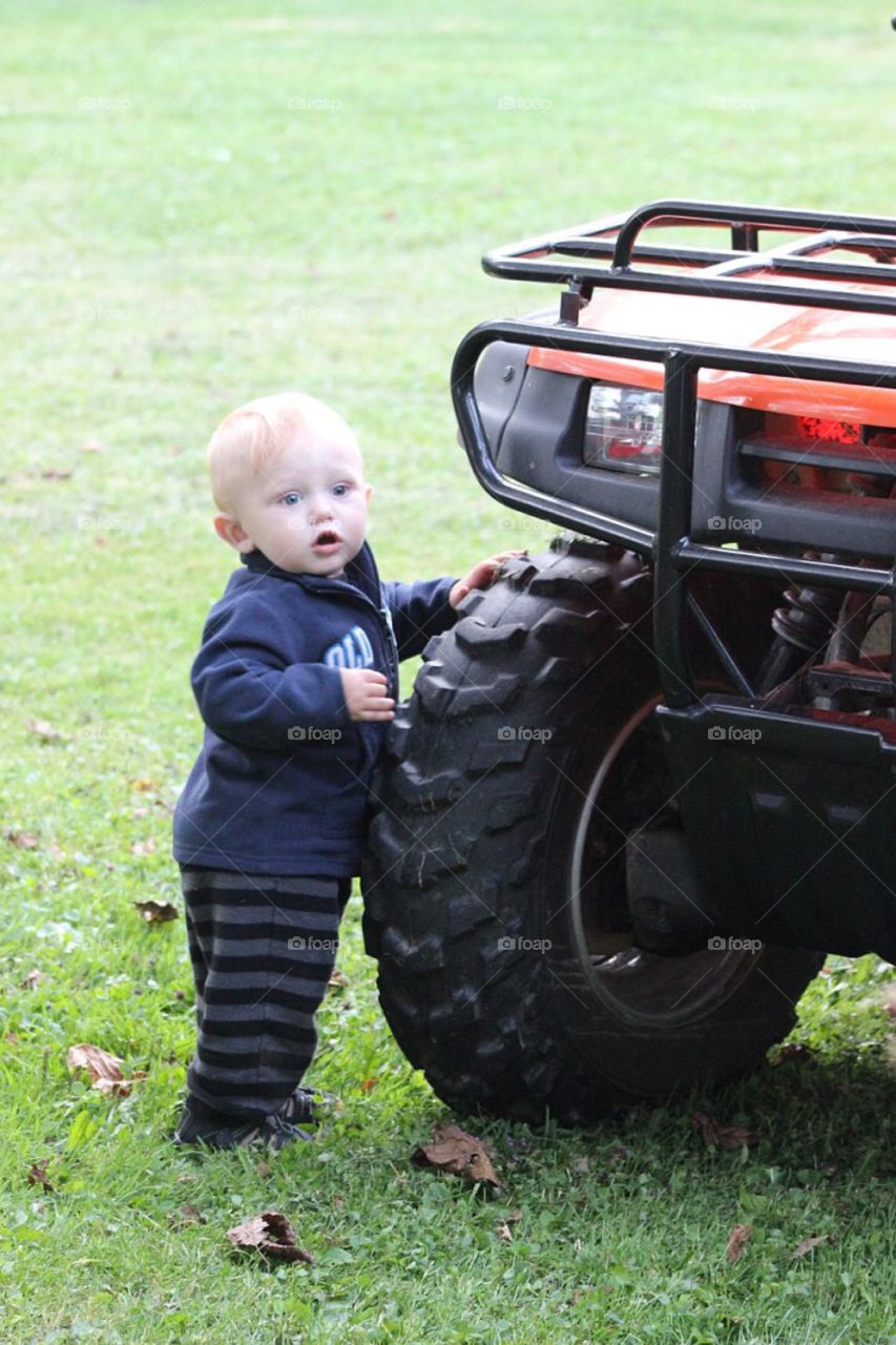 Cute blonde boy in garden