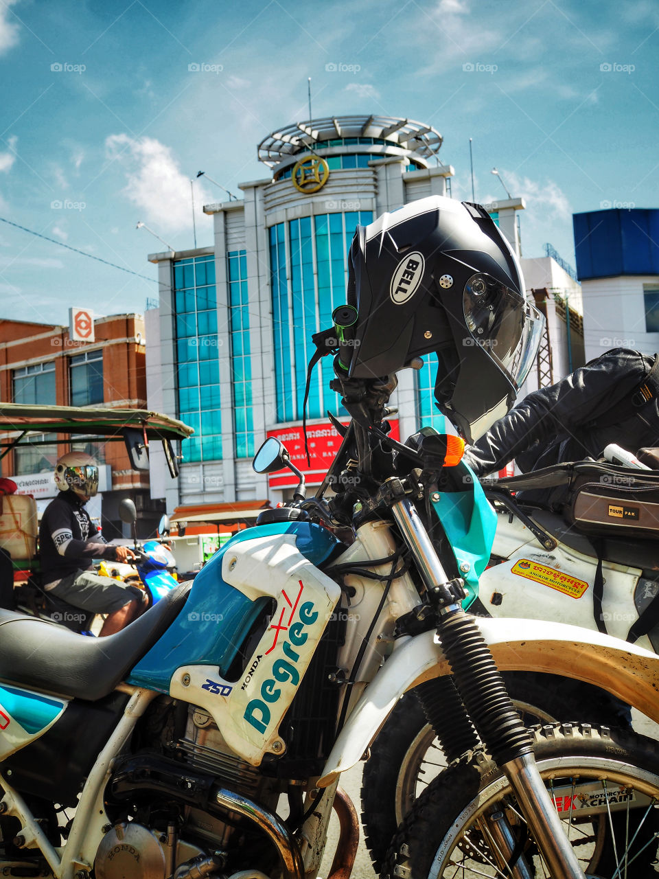 Honda Degree and Bell helmet in traffic in Cambodia 