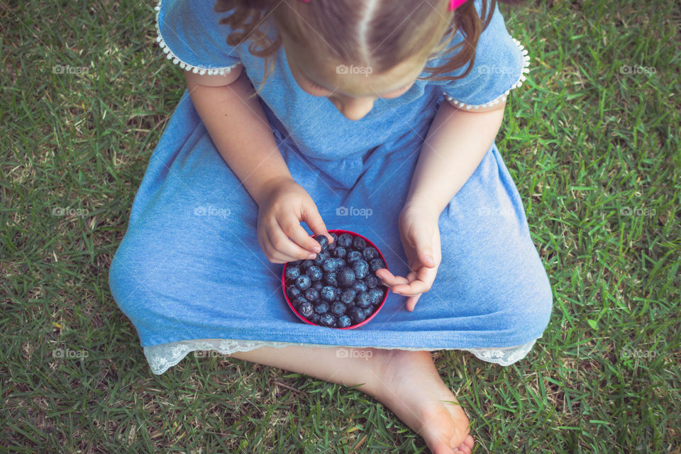 Young Girl with Pink Hairbows Eating Blueberries 18