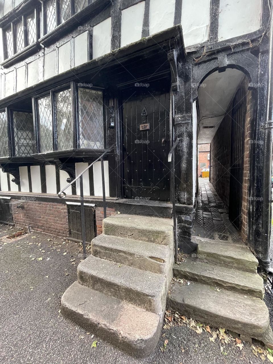 Very old unusual building with a little side alley next to the front door ?!?! 