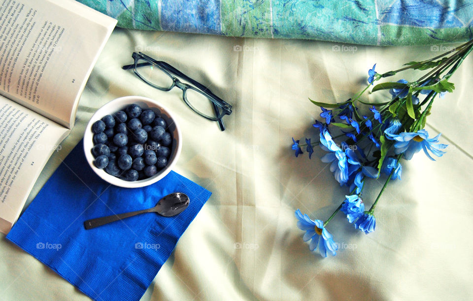 breakfast in bed, blue theme, flat lay, story, book, reading, glasses, blueberry, milk, framing elements, healthy, snack, comforter