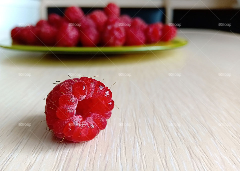 ripe raspberries on the table close-up