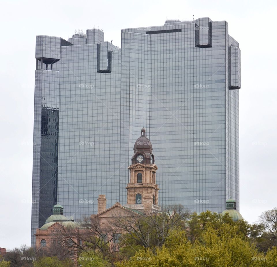 Old Fort Worth courthouse with modern skyscraper in the background. 