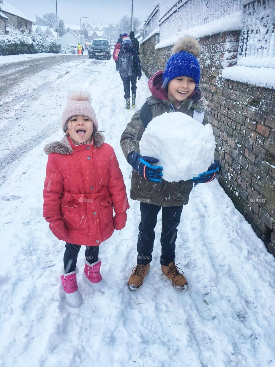 Children funning with snow