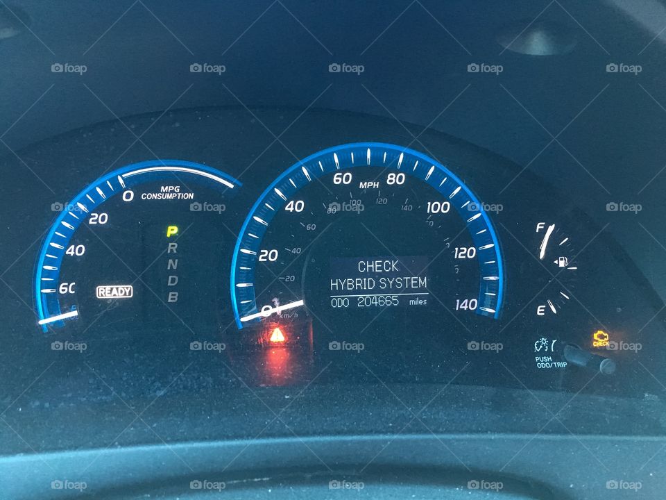 Check hybrid system warning and check engine light on Toyota Camry Hybrid dashboard 