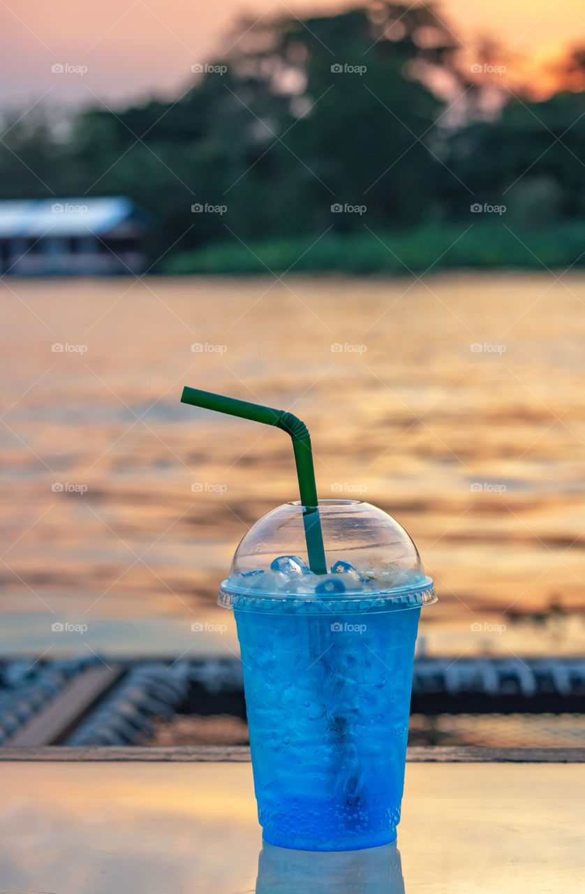 Italian soda cold Blur background Khwae Noi river And sunset light