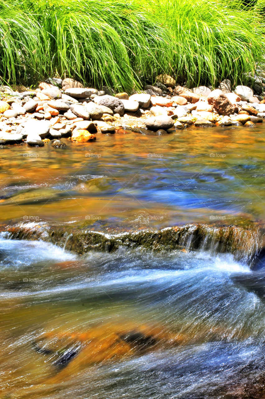 A stream runs through a shallow river 