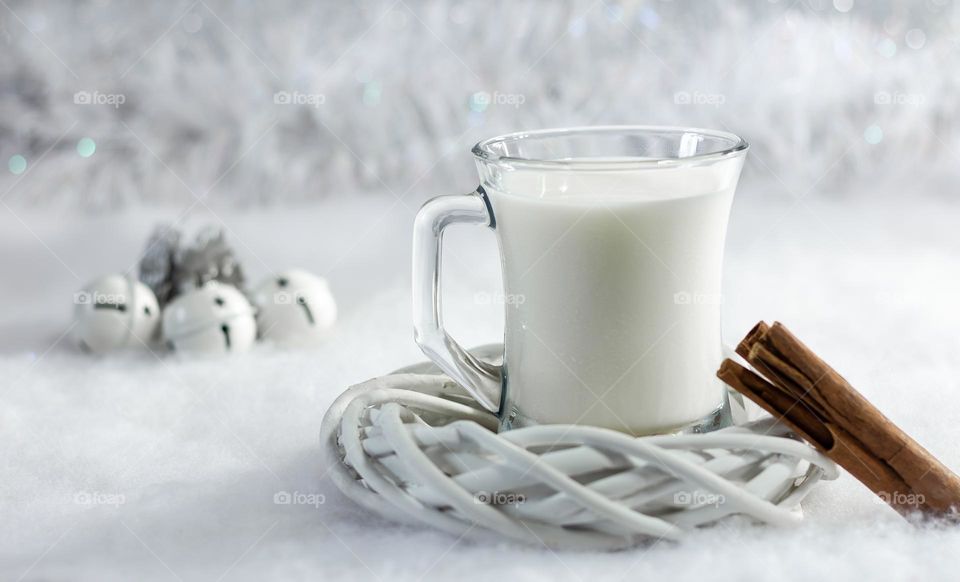 Warm milk and cinnamon on a soft, white and sparkly background