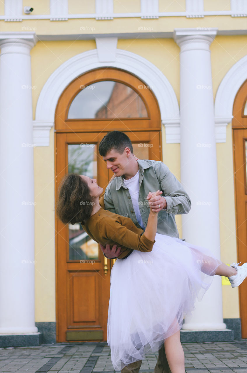 Love story of stylish funny couple. People walking, dancing and kissing in the autumn city. Wedding celebration and date concept.