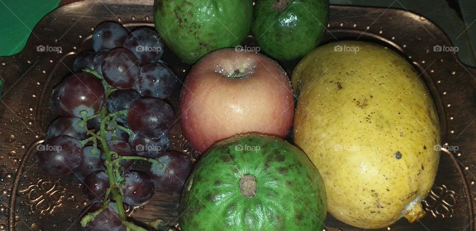 guava, apple, grapes on the table