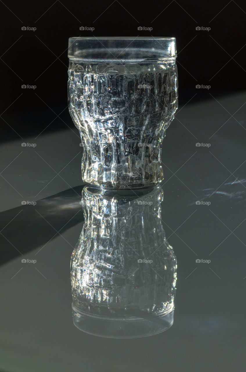 double: glass of water on the glass table.