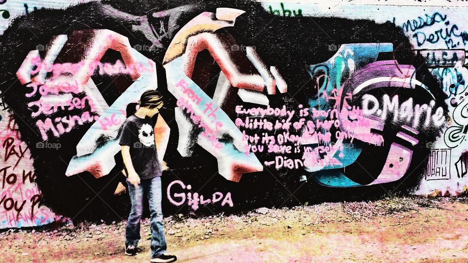 words of wisdom. my daughter standing in front of a graffiti wall in Austin