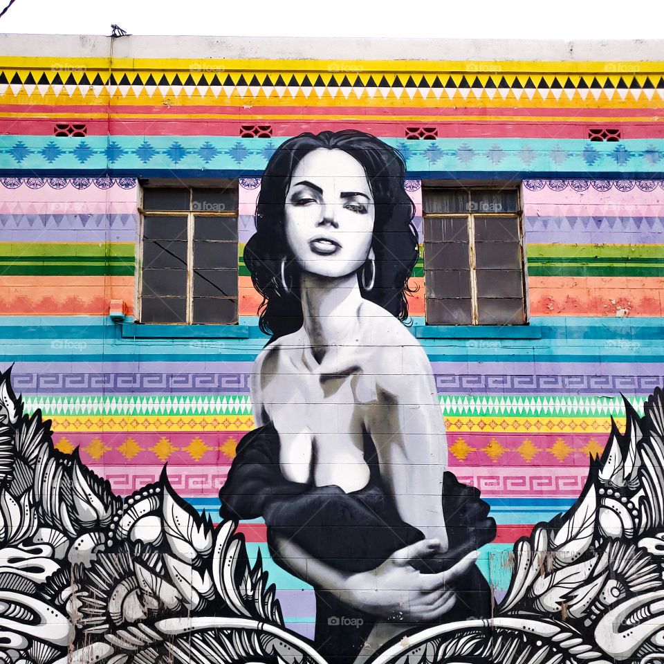 Colorful cultural street art of a beautiful Hispanic woman.