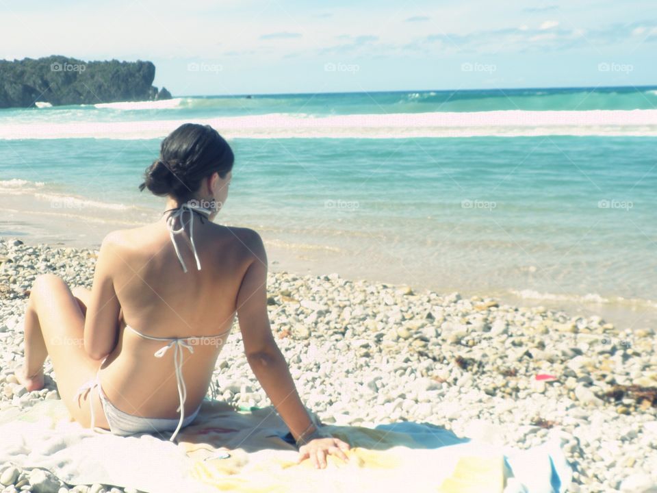 Beautiful young woman enjoying the beach in  Asturias, Spain