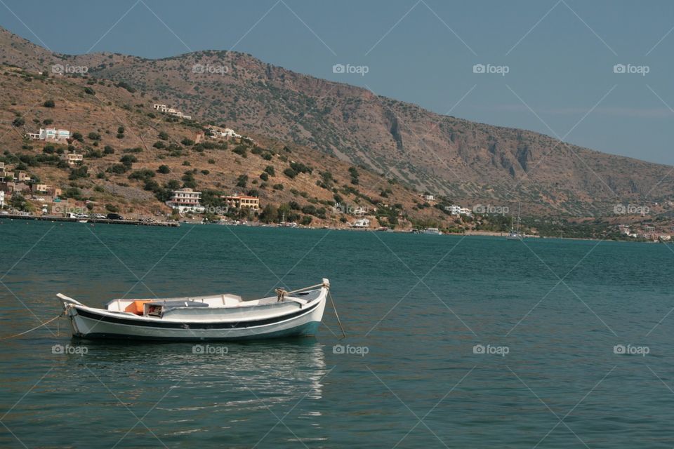 Boat sailing on sea against clear sky