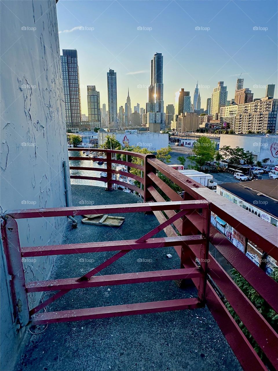 This is the central outpost of the “Pulaski Bridge” at “Newtown Creek” that connects “Greenpoint”, Bklyn to LIC, Queens. Across the “East River” we see “Manhattan” and the “Empire State Building”. 2024. Hypnotic Productions
