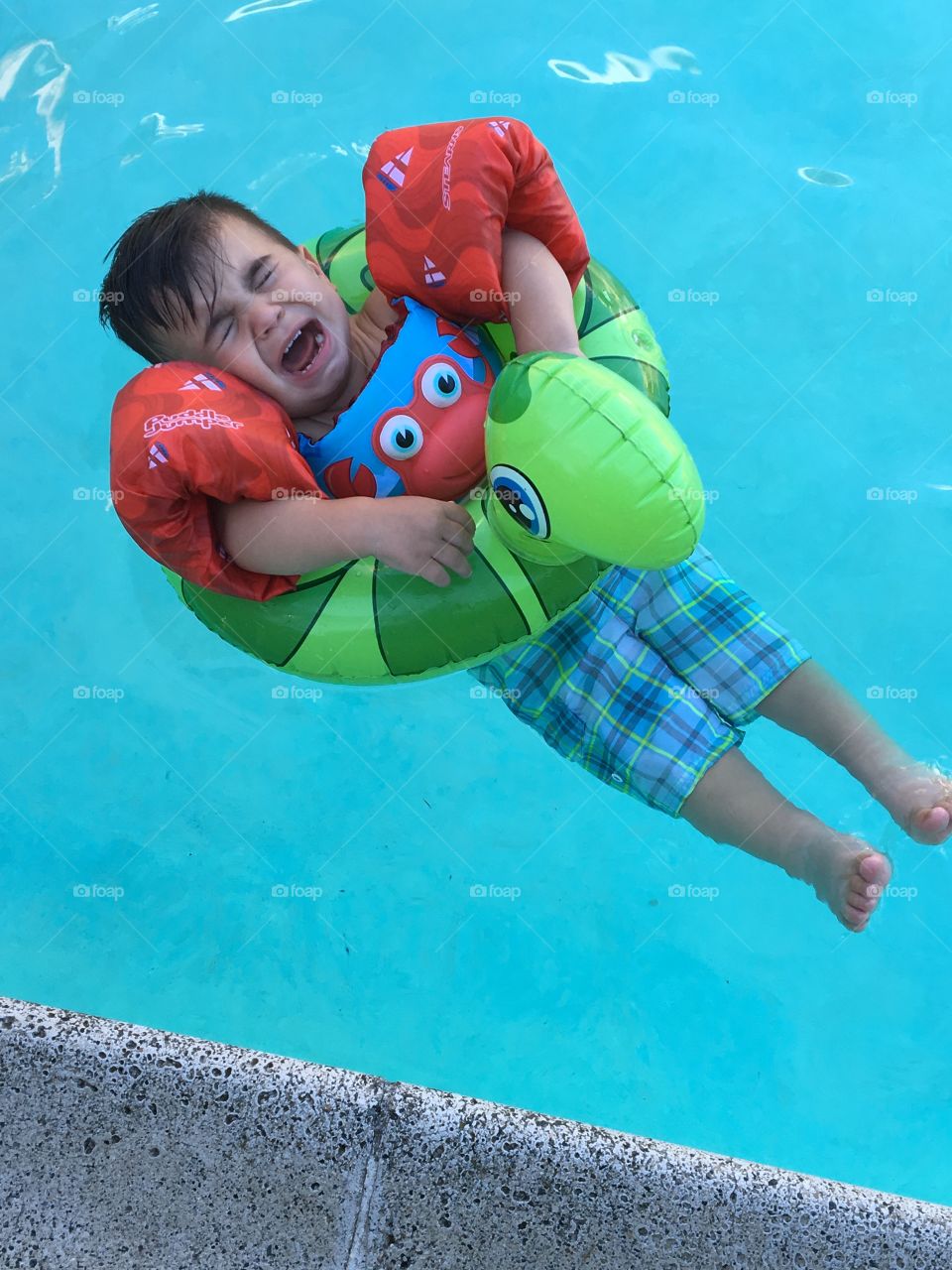 Unhappy swimming baby