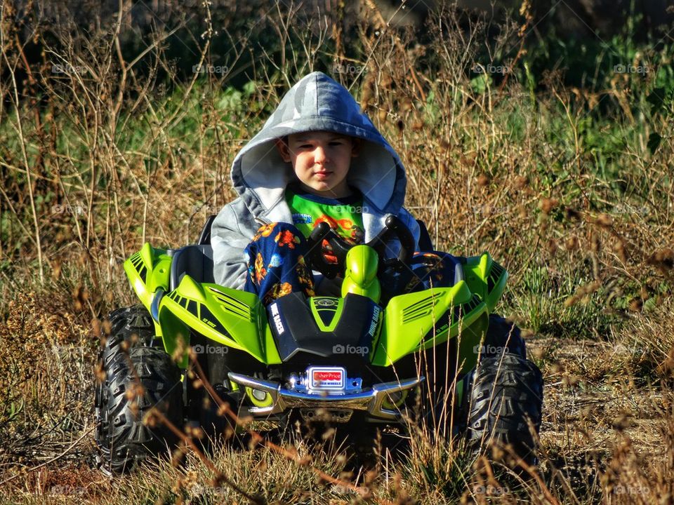 Young boy riding ATV