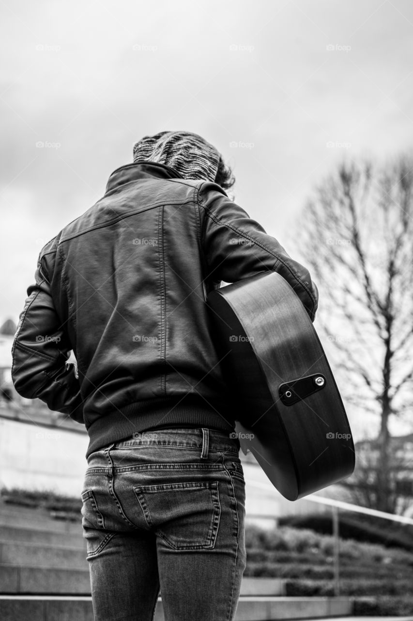 Rear view of a man playing guitar