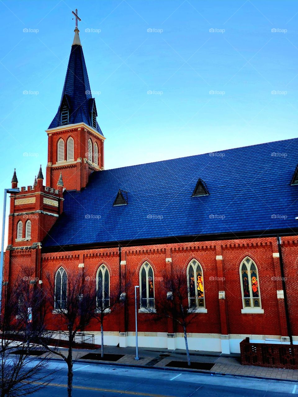 As a day draws to a close, the setting sun's last act is to light up a couple of stained glass windows in an old church