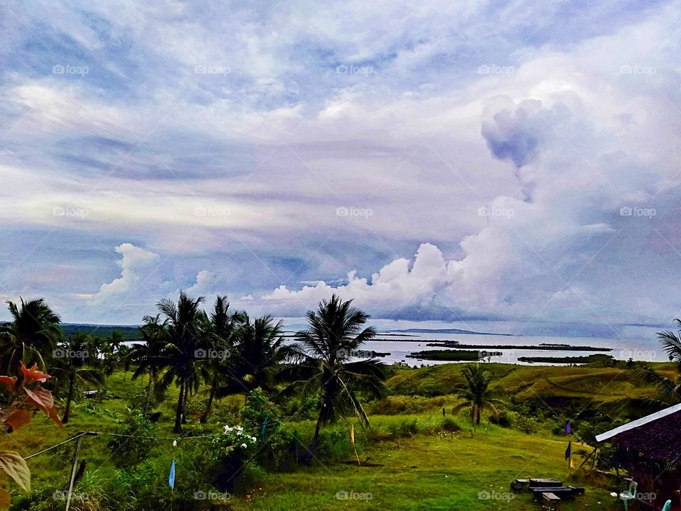 Beautiful rare cloudscape with green valley and trees, Nature photography.