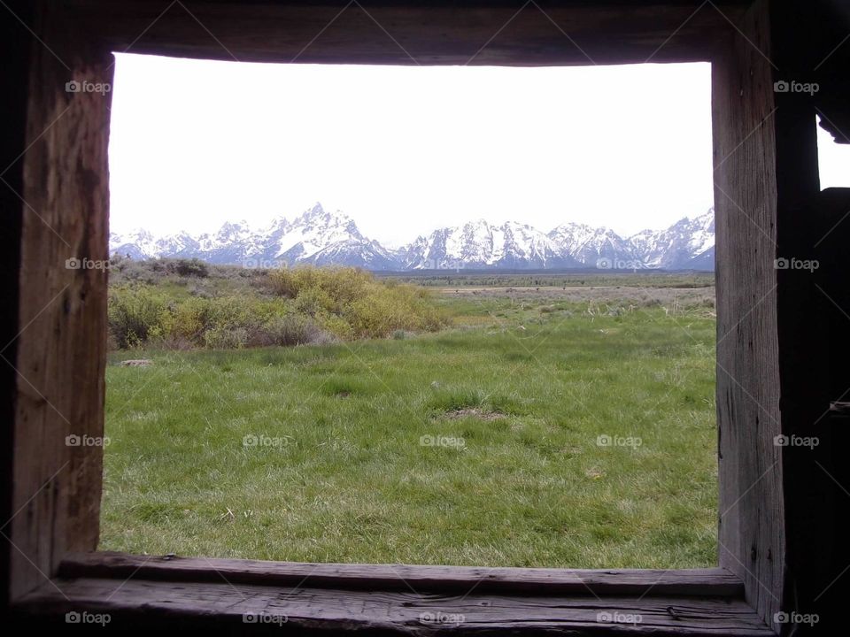 Mountains seen from the window of an old cabin. 