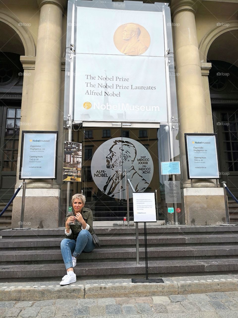Girl sitting in front of Alfred Nobel museum.
