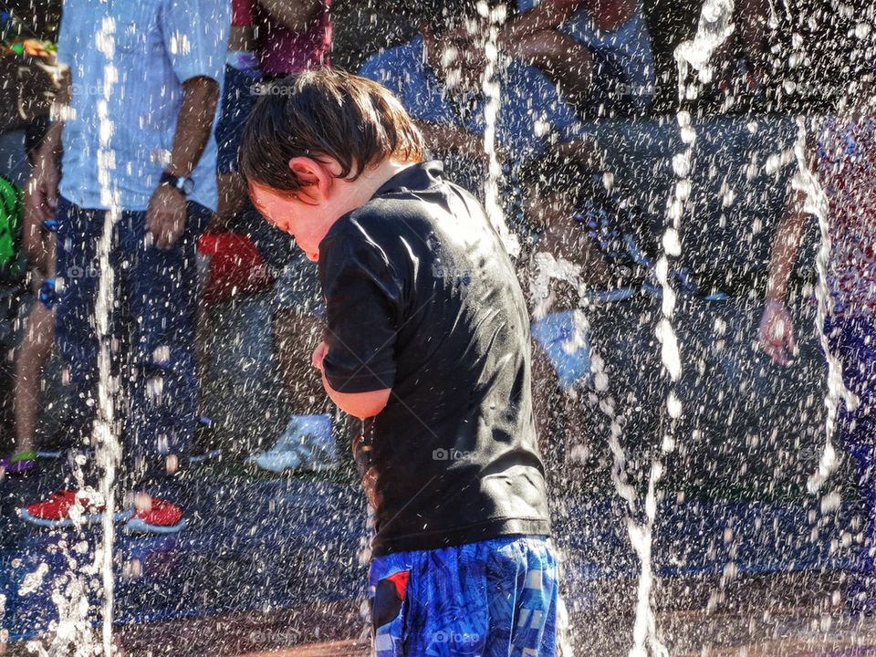 Playing In Water Fountain. Cooling Off In The Summertime
