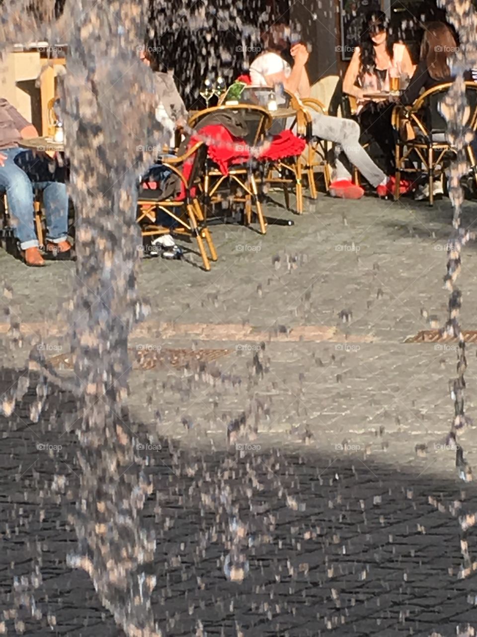 A look through the falling water of the fountain
