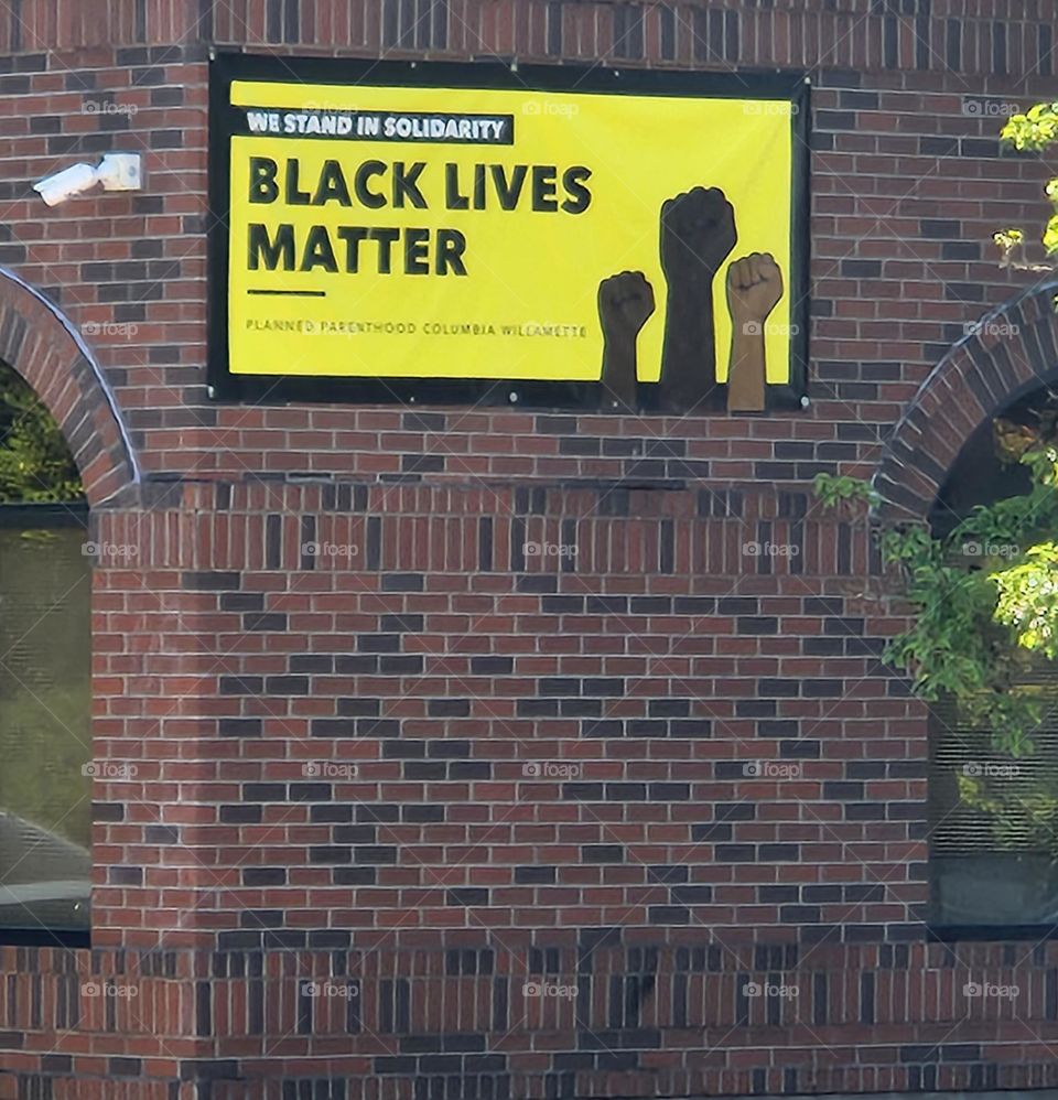 Black Lives Matter solidarity poster on brick planned parenthood building in Oregon