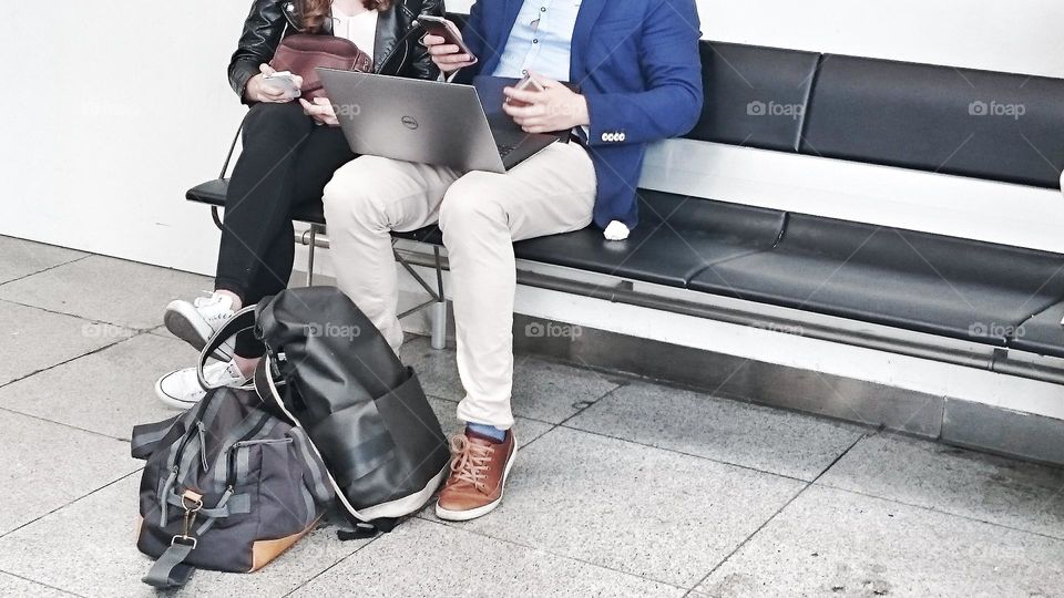 People on their smartphones / airport / travel