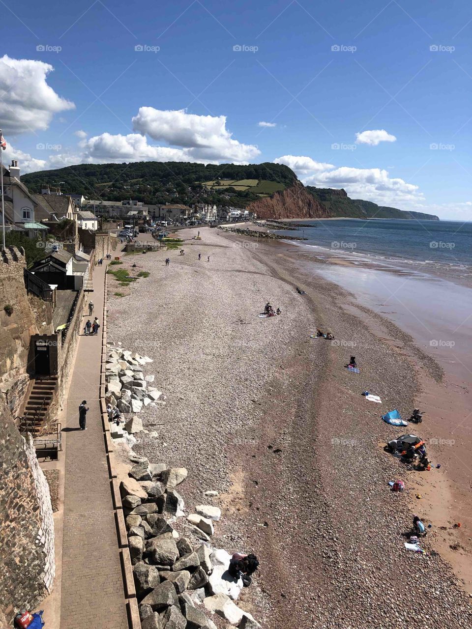View from in high of Sidmouth Beach, Town Centre end, even though this section is pebbled visitors flock to this landmark beach in August.