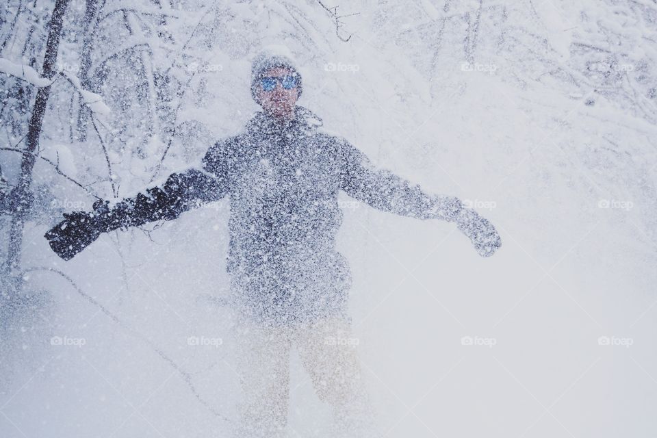 Front view of a man covered in falling snow